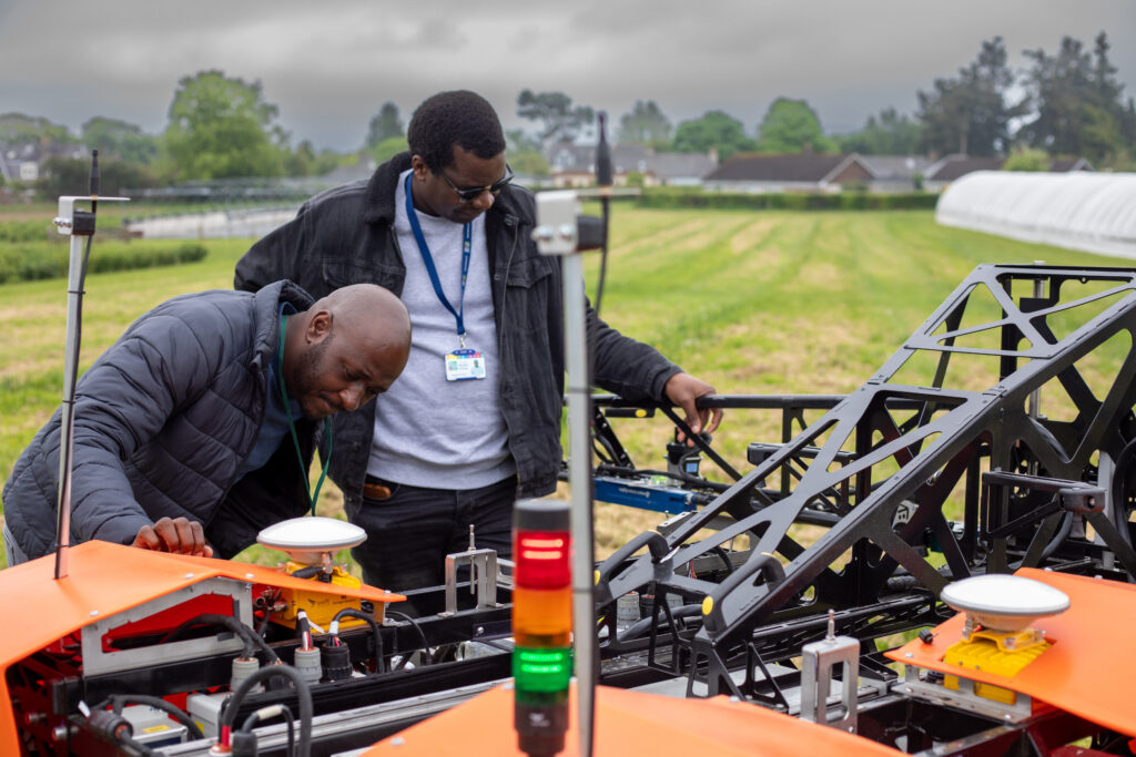 BARIToNE students Nigel and Happison inspecting the imaging robot